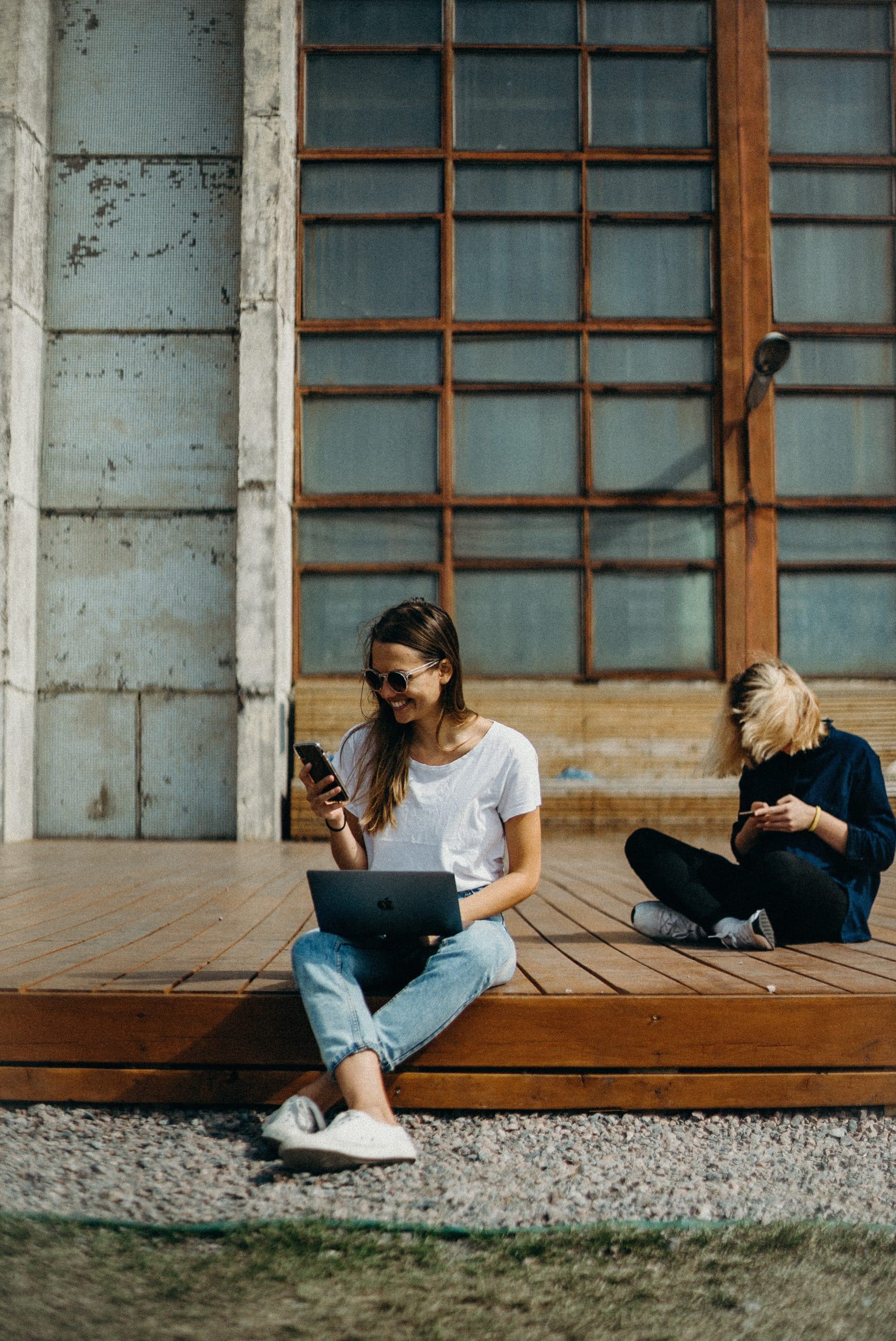 A marketing team succesfully working on an influencer marketing plan over a table with all their laptops and equipment.